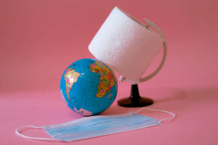 Earth globe ,toilet paper and face mask on pink backgroundのeditorial素材