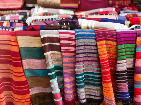 Morocco,Medina of Essaouira. 15 August 2018: Handmade cotton and Silk scarf.Multi different colors and patterns on the market,in a factory shop or store or bazar. card from Moroccoのeditorial素材
