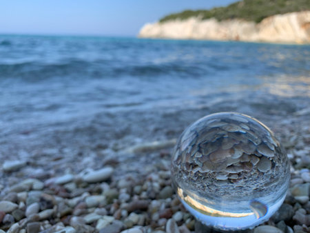 close up crystal glass ball at the beach.