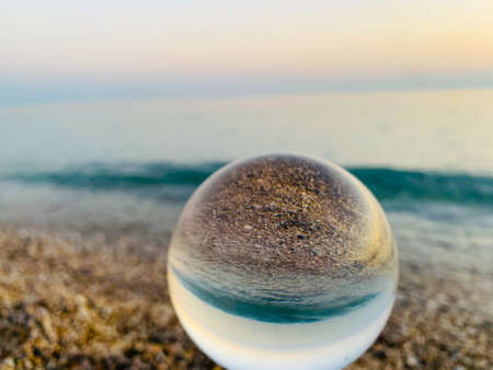 close up crystal glass ball at the beach.の写真素材