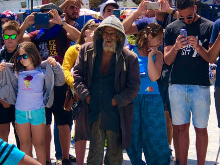 A homeless man among tourists. summer holidaysのeditorial素材