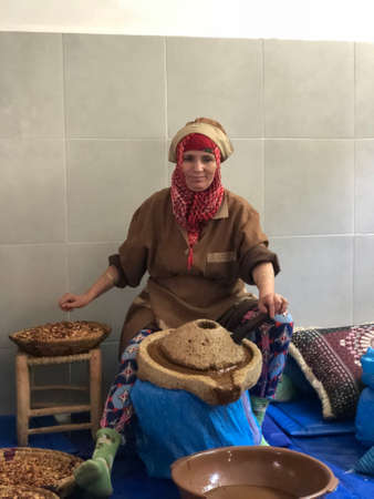 Moroccan woman producing argan oil by traditional methods.のeditorial素材