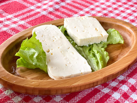 White cheese on a wooden plate. Food ang drinks.