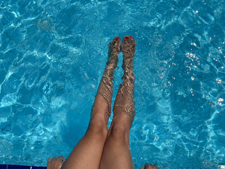 close up woman feet in swimming pool.summer holiday concept.
