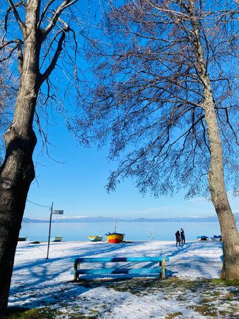 Ohrid lake, snow, sky and the town of Pogradec in Albania.の写真素材