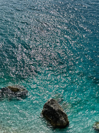 Rocky beach and crystal turquoise water of Ionian Sea in Albania.