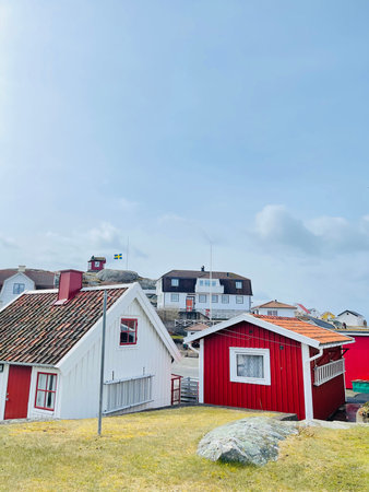 A view of red wooden houses on Vrango Archipelago island .