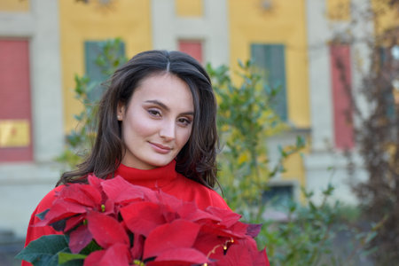 Close up beautiful Caucasian white girl holding a Christmas flowers.のeditorial素材