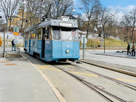 View on a blue new style tram on stop with people .のeditorial素材