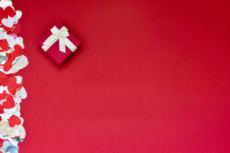 Hearts of paper on red textured background. San Valentine day concept.