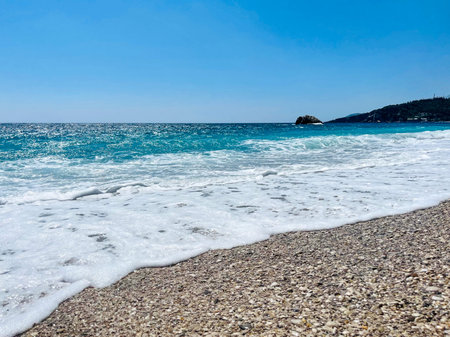 Rocky beach and crystal turquoise water of Ionian Sea in Albania.