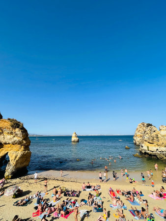 Busy beach on the Algarve coast on a summers day.のeditorial素材