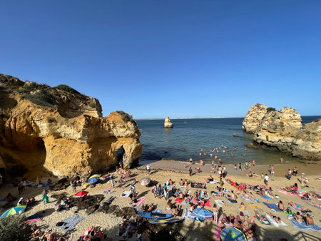 Busy beach on the Algarve coast on a summers day.のeditorial素材