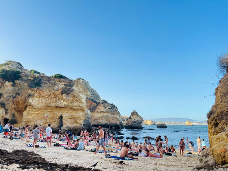 Busy beach on the Algarve coast on a summers day.のeditorial素材