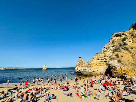 Busy beach on the Algarve coast on a summers day.のeditorial素材