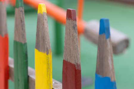 Close up multi colored fence in the form of large colored pencils. Copy spaceの写真素材