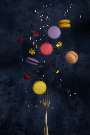French macarons flying in the air on black background.の写真素材