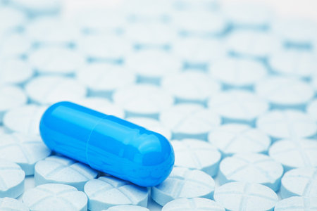 Blue Medical pill on background of pure blue pillsの写真素材