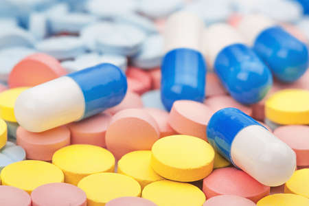 Pile of medical tablets and pills in the different colorsの写真素材