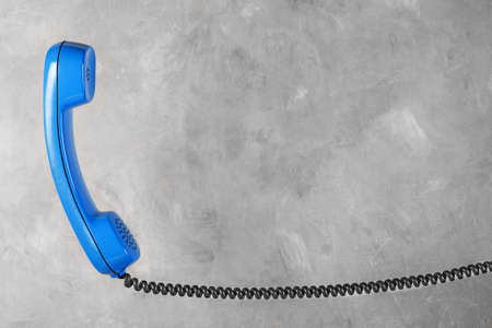 handset from landline phone on the background wallの写真素材