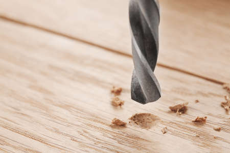 drill bit make holes in wooden oaks plankの写真素材