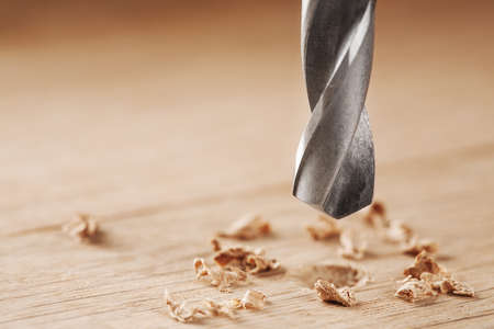 drill bit make holes in wooden oaks plankの写真素材