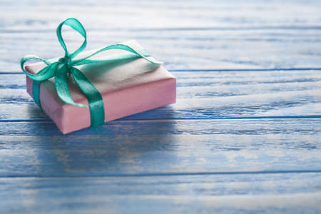 Gift boxes in paper on blue wooden tableの写真素材