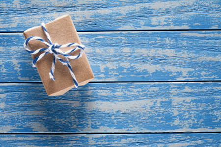 Gift boxes in paper on blue wooden tableの写真素材