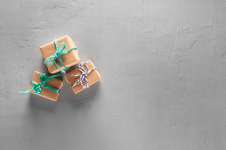 Gift boxes in craft paper on concrete backgroundの写真素材
