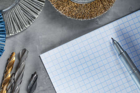 workplace on a concrete with paper drill bit, tools, grinding discsの写真素材