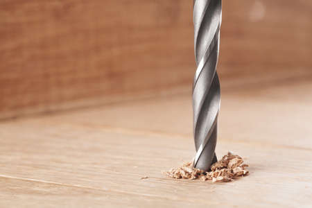 metal drill bit make holes in wooden oaks plankの写真素材