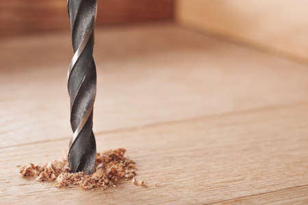 metal drill bit make holes in wooden oaks plankの写真素材