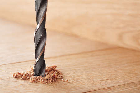 metal drill bit make holes in wooden oaks plankの写真素材