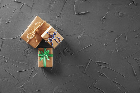 Gift boxes in craft paper on concrete background