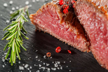 grilled steak with rosemary on a  wooden backgroundの写真素材