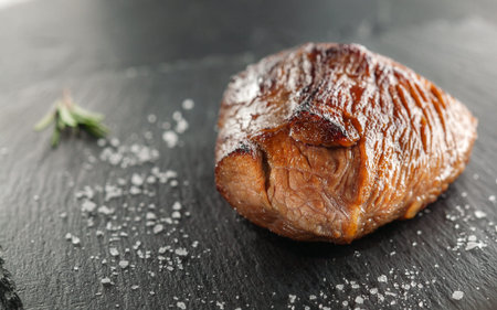 grilled steak with rosemary on a  wooden backgroundの写真素材
