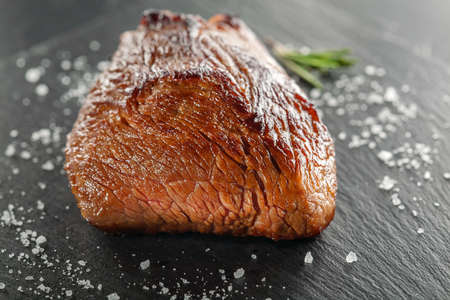 grilled steak with rosemary on a  wooden backgroundの写真素材