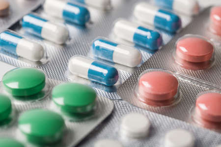 Pile of medical tablets and pills in silver plastic boxesの写真素材