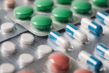 Pile of medical tablets and pills in silver plastic boxesの写真素材