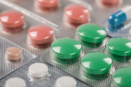 Pile of medical tablets and pills in silver plastic boxesの写真素材