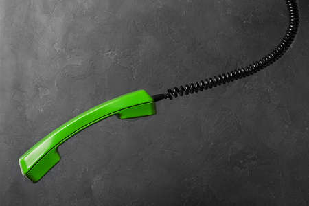 handset from landline phone on the background wallの写真素材