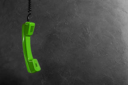 handset from landline phone on the background wallの写真素材