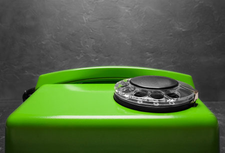 landline green phone on a gray wall backgroundの写真素材