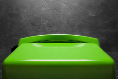 landline green phone on a gray wall backgroundの写真素材
