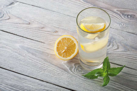 Lemonade of fresh mint and lemon on a wooden backgroundの写真素材