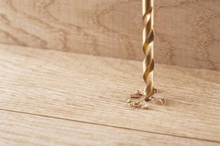 metal drill bit make holes in wooden oaks plankの写真素材