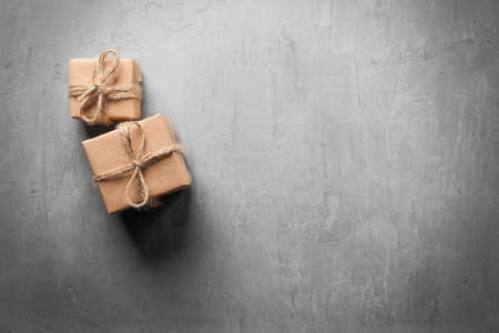 Gift boxes in craft paper on concrete backgroundの写真素材