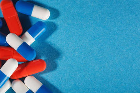 Medical pills white-blue and red on a bright backgroundの写真素材