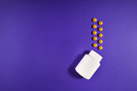 Medical pills vitamins on a colored background with a vialの写真素材