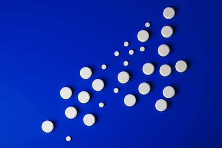 medical pills round shape and bright bottle blue backgroundの写真素材